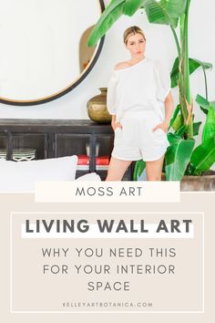 a woman standing in front of a mirror with the words moss art living wall art why you need this for your interior space