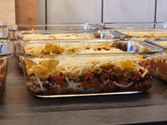 several casserole dishes are lined up on a counter top and ready to be eaten