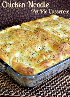 chicken noodle pot pie casserole in a glass dish on a wicker place mat