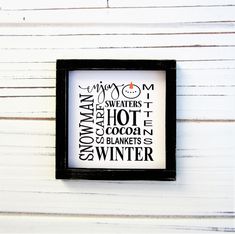 a black and white framed sign with words on it that say winter in different languages