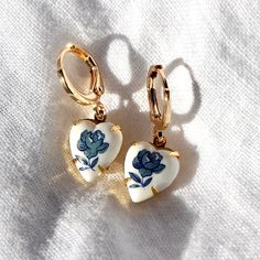 These earrings are composed of 11x10mm vintage heart shaped cabochons that feature a delicate blue floral detailing on the front. The stones have been set in a durable, 18k gold or silver plated setting. The charms are attached to 12mm plated hoops. Please note, there are small variances in the design due to the vintage nature of the stones. Pictured in gold, but a silver finish is available. Cheap Vintage Blue Earrings, Affordable Vintage Everyday Earrings, Cheap Vintage Spring Jewelry, Cheap Vintage Everyday Earrings, Affordable Vintage Spring Jewelry, Shopping Vintage Accessories, Affordable Vintage Hoop Earrings Gift, Affordable Blue Everyday Jewelry, Affordable Everyday Blue Jewelry