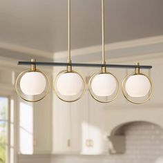 three lights hanging from the ceiling in a kitchen