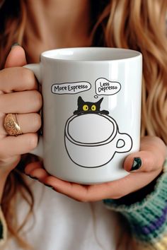 a woman holding a coffee mug with a cat drawn on it