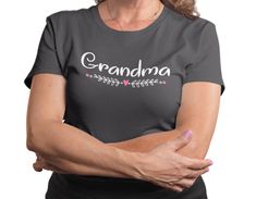 a woman with her arms crossed wearing a t - shirt that says grandma