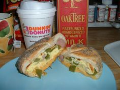 a sandwich cut in half sitting on top of a blue plate next to a cup