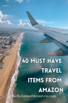 an airplane wing flying over the ocean with text reading 40 must have travel items from amazon