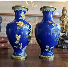 two blue vases sitting on top of a wooden table