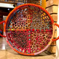 a colorful basket is hanging on the wall