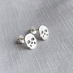 Real 925 Sterling Silver Tiny Skull Stud Earrings These lovely earrings can be used in Earlobe, Tragus and Cartilage. Measures 9x8mm Comes with pushback backings Sold by Pair Jewelry will come in a gift box * Please read shop policy before placing an order * *JEWELRY CARE* Sterling Silver will tarnish over time, but to help keep your jewelry looking beautiful - Clean with a soft dry cloth after wear and store inside an airtight bag or container. Remember to remove your jewelry when: * Applying l Minimalist Skull Jewelry Gift, Nickel-free Sterling Silver Skull Jewelry, Sterling Silver Skull Earrings For Gift, Handmade Sterling Silver Skull Earrings, Second Hole Piercing, Dagger Earrings, Paired Jewelry, Tragus Piercings, Cartilage Earrings