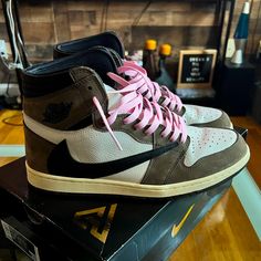 Travis Scott X Air Jordan 1 Retro High Og 'Mocha' Worn 1 Time Around House 100% Authentic Size 12 Only Comes W/ Pink Laces Comes W/ Box But Not Original Box $1700 On Goat, Stadium Goods, Etc The Travis Scott X Air Jordan 1 Retro High Features A New Look On The Iconic Silhouette, Thanks To An Oversized Backward-Facing Swoosh On The Lateral Side. A Traditionally Oriented Swoosh Graces The Medial Side Of The Upper, Which Is Built With A Blend Of White Leather And Brown Suede. Additional Unique Deta Pink Mid-top Custom Sneakers With Contrast Sole, Pink Mid-top Custom Sneakers For Streetwear, Travis Scott Jordans, Travis Scott Aj1, Travis Scott Jordan 1, Cute Nike Outfits, Mocha Color, Face Logo, Air Jordan 1 Retro High Og