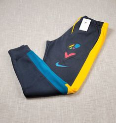 NIKE Jogger Pants Medium XL 2XL  Mens Peace Love Basketball Gray Blue Yellow BRAND NEW WITH TAGS COLOR: GRAY BLUE YELLOW MEN'S SIZES AND MEASUREMENTS MEDIUM Waist: 15 inches ( across ) Length: 39 inches Inseam: 28 inches XL Waist: 17 inches ( across ) Length: 40 inches Inseam: 29 inches 2XL Waist: 18 inches ( across ) Length: 41 inches Inseam: 29 inches Shipped with USPS Priority Mail except on weekends and holidays. * Please note, USPS is experiencing an increase in packages. Delivery times may Nike Jogger Pants, Nike Jogger, Love Basketball, Nike Joggers, Love And Basketball, Active Wear Pants, Mens Joggers, Dress Code, Peace Love