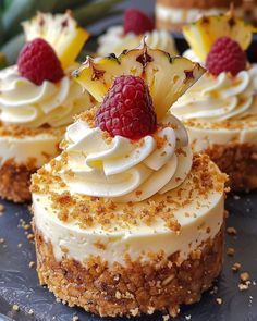 three desserts with fruit on top are sitting on a blue platter, ready to be eaten