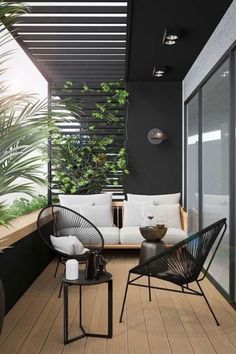 an outdoor living area with black and white furniture