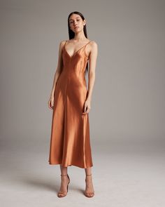 This elegant bias-cut slip dress features a spaghetti strap and flattering V Neck for a fresh, yet refined look. This perfect basic can be worn for life, dressed up, or dressed down, for the perfect effortless ensemble. 100% Silk Charmeuse Made in New York City Product Care: Dry Clean Only Formal V-neck Slip Dress With Delicate Straps, Elegant Solid Color Slip Dress For Night Out, Elegant Midi Slip Dress With Adjustable Straps, Chic Formal Slip Dress With Adjustable Straps, Chic Slip Dress With Adjustable Straps For Formal Events, Classic Slip Dress For Night Out, Elegant Midi Dress With Delicate Straps For Brunch, Elegant Cami Dress With Delicate Straps, Chic V-neck Slip Dress For Dinner