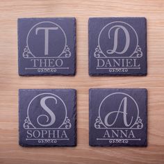 three personalized slate coasters with the letter d, t, and s on them