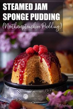 a cake with raspberries on top and the words steamed jam sponge pudding