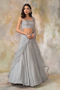 Grey lehenga with embellished detail. Comes with embellished blouse and dupatta.
Components: 3
Fabric: Georgette, Net
Neckline: Sweetheart
Sleeve Length: Sleeveless
Color: Grey
Embellished
Net dupatta 
Tassel detail - Aza Fashions Grey Lehenga, Cutwork Blouse, Lehenga Designs Simple, Independance Day, Lehenga Blouse Designs, Net Lehenga, Embroidered Lehenga, Lehenga Blouse, Embellished Blouse