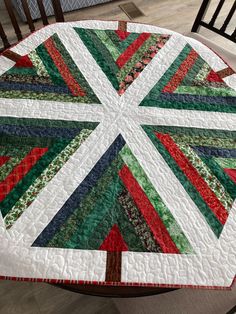 a quilted table top sitting on top of a wooden chair