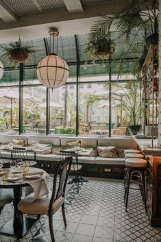 the inside of a restaurant with tables and chairs