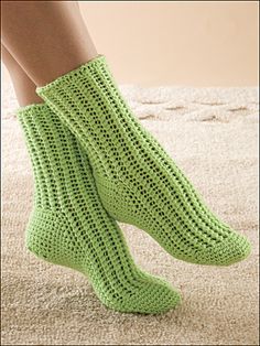 a woman's legs wearing green knitted socks