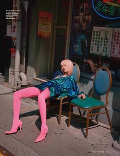 a mannequin is sitting on a chair in front of a store with pink tights