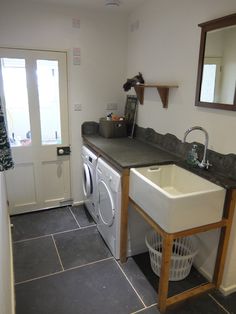 a laundry room with a washer and dryer next to a door that is open