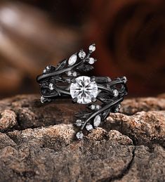 a diamond ring sitting on top of a rock