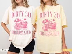 two women wearing dirty 30th birthday t - shirts, one in yellow and the other in pink