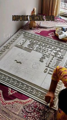 a woman laying on top of a rug in front of a window with the words mudwork working video