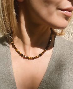 Tigers eye beaded necklace. This classic beaded necklace is made of genuine Tiger's eye stone and 14k gold filled donut beads and magnetic clasp. Ideal for layering, but looks great on its own too. Necklace length is 42 cm or 16.5 inches. Beads measure 6 mm. Handmade in Spain. Free shipment with registered trackable post. SPECIAL OFFERS: ✦ Special 10% OFF when you order 2 items!! Apply Coupon Code: SAVEMORE2 ✦Special 15% OFF when you order 3 or more items!! Apply Coupon Code: SAVEMORE3 You might Tigers Eye Beaded Necklace, Tigers Eye Jewelry Ideas, Everyday Gemstone Beaded Necklaces, Everyday Beaded Necklaces With Natural Stones, Everyday Round Beaded Necklaces With Natural Stones, Everyday Gold Beaded Necklace With Natural Stones, Everyday Spiritual Brown Necklace, Tigers Eye Jewelry, Tiger Eye Jewelry