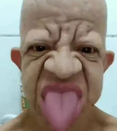 a bald man with his tongue sticking out