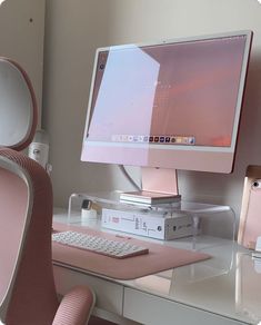 a computer monitor sitting on top of a desk next to a keyboard and mouse pad