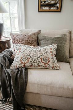 a couch with pillows and blankets on it