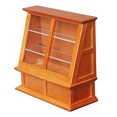 a wooden display case with glass doors on the front and bottom shelves, in light wood