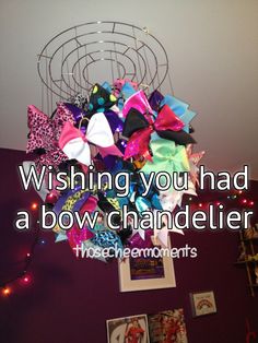 a bunch of colorful hair bows hanging from a chandelier in a living room