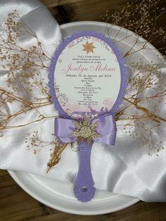 a white plate topped with a purple ribbon