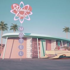 a pink motel with palm trees in the background and a sign that says atomic house