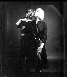 a black and white photo of a woman drinking from a bottle