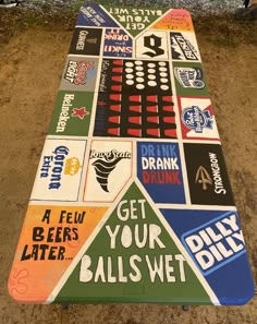 a long table covered in different types of stickers on it's sides and the words, get your balls wet