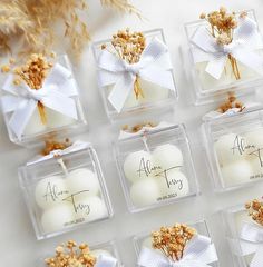 the wedding favors are arranged in small clear boxes