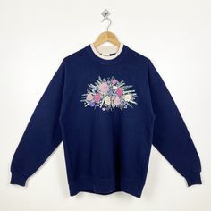 90s Art Flowers Crewneck Sweatshirt Print Logo Blue Color Women's L - Made in Usa - Materials : Cotton, Polyester  - Tag Reads : Women's L Kindly see the actual measurements (All measurements were taken lying flat) - Actual size manual measurements * Width (Armpit to armpit) : 23 inches * Length (Shoulder to end of garment) : 27.5 inches * Sleeve length : 23 inches - Condition : * Vintage condition 8/10 (80%) * Minor stain refer picture * Free from any tear and major defect - Shipping : * DHL Express/FedEx Express = 3-6 business day arrived * Please PROVIDE your PHONE/CONTACT NUMBER for SHIPPING/DELIVERY purpose DON'T FORGET TO VISIT MY SHOP FOR MORE GREAT STUFF, THANK YOU. Blue 90s Graphic Print Sweatshirt, 90s Blue Graphic Print Sweatshirt, 90s Blue Graphic Sweatshirt, Blue Retro Sweater With Graphic Print, Vintage Blue Sweatshirt With Graphic Print, 90s Blue Cotton Sweater, 90s Style Blue Cotton Sweater, Vintage Oversized Blue Sweatshirt, Oversized Blue Vintage Sweatshirt