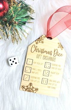 a wooden christmas gift tag next to a dice