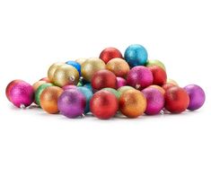 a pile of colorful christmas balls on a white background