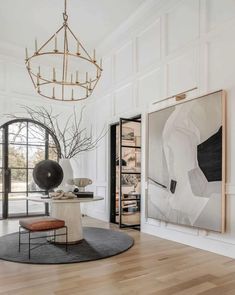 a living room with white walls and wood floors