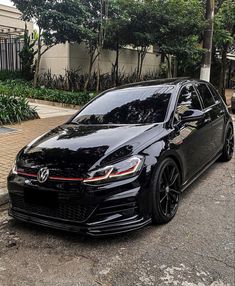 a black volkswagen golf gtr parked on the street