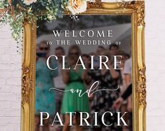 a wedding welcome sign with flowers and greenery