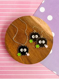 two black and white hedgehogs with green stars on them are sitting on a wooden plate