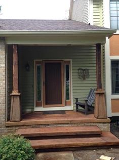 a porch with steps leading to the front door