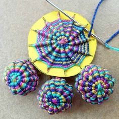 there are four crocheted balls on the table