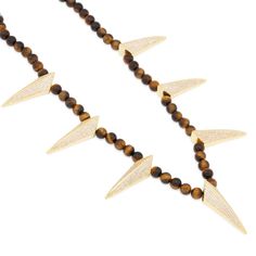 With semi precious, Tiger-Eye gemstones, the Wakanda inspired necklace mixes street and contemporary that brings versatility to any ensemble. The stainless steel link chains inside offers stability and quality while the 14K gold plated claws displays a vibrant shine. In addition, the custom clasps provides an easy but secure lock that adds a Wakanda inspired design. Luxury Brass Gemstone Necklaces, Gold Plated Gold Necklace With Stones, Modern Yellow Gold Jewelry With Stones, Unique Gold Jewelry With Stones, Gold Sterling Silver Beaded Necklace With Gemstone Beads, Luxury Gold Beaded Necklaces With Natural Stones, Luxury Gold Beaded Necklace With Natural Stones, Gold Long Beaded Necklaces With Stones, Modern Gold Necklace With Beaded Chain